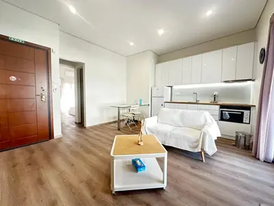 a living room with a couch and a table at Athens 5th Floor Retreat, Blissful Escape in Athens