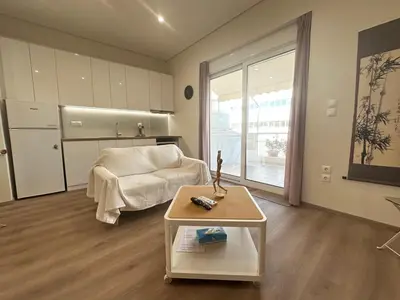a living room with a couch and a table at Athens 5th Floor Retreat, Blissful Escape in Athens