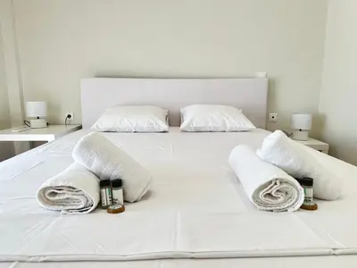 a white bed with towels and candles on it at Athens 5th Floor Retreat, Blissful Escape in Athens