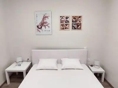 a bedroom with a white bed and two tables at Athens 5th Floor Retreat, Blissful Escape in Athens