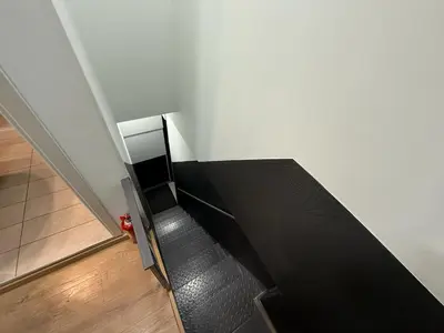 a staircase in a room with a black couch at Στούντιο στο Κέντρο της Πόλης in Athens