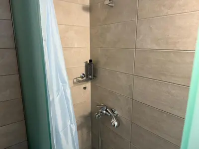 a bathroom with a shower with a shower curtain at Στούντιο στο Κέντρο της Πόλης in Athens
