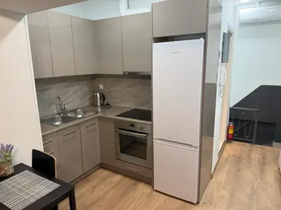 a kitchen with a refrigerator and a sink and a table at Στούντιο στο Κέντρο της Πόλης in Athens