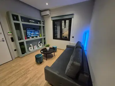 a living room with a couch and a table at The Urban Nest 1 in Athens