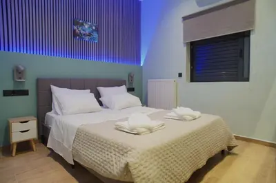 a bedroom with a bed with two towels on it at The Urban Nest 1 in Athens