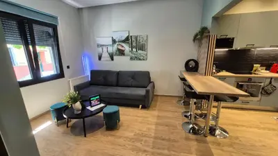 a living room with a couch and a table at The Urban Nest 1 in Athens