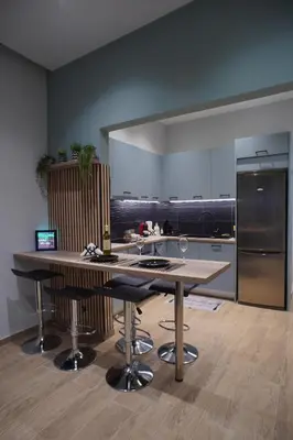 a kitchen with a large island with bar stools at The Urban Nest 1 in Athens