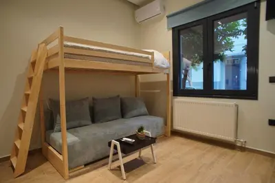 a living room with a couch and a bunk bed at The Urban Nest 2 in Athens