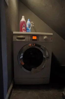 a washing machine with bottles on top of it at The Urban Nest 2 in Athens