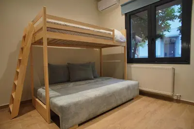 a bedroom with a bunk bed and a window at The Urban Nest 2 in Athens