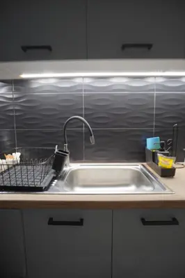 a kitchen sink with a faucet on top of it at The Urban Nest 2 in Athens