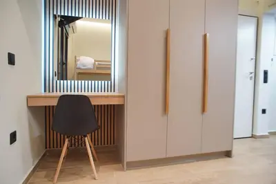 a desk with a mirror and a chair in a room at The Urban Nest 2 in Athens