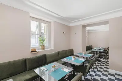 a restaurant with couches and tables and a window at Morus Acropolis Boutique Hotel in Athens