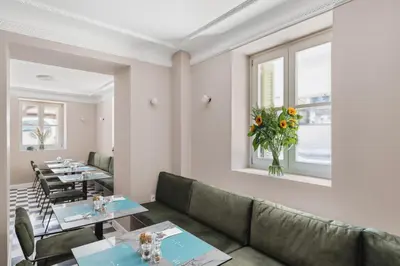 a restaurant with tables and chairs and a couch at Morus Acropolis Boutique Hotel in Athens