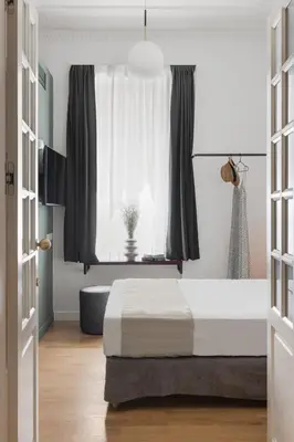 a bedroom with a bed in front of a window at Morus Acropolis Boutique Hotel in Athens