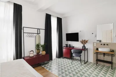 a bedroom with a bed and a desk with a computer at Morus Acropolis Boutique Hotel in Athens