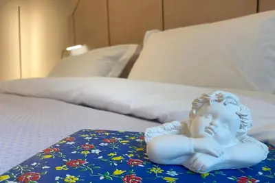 a statue of a baby sitting on a bed at Live in Athens, PANGRATI Fine Residence in Athens