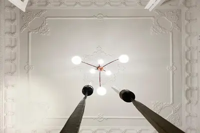 a clock hanging on a wall in a room at Live in Athens, PANGRATI Fine Residence in Athens