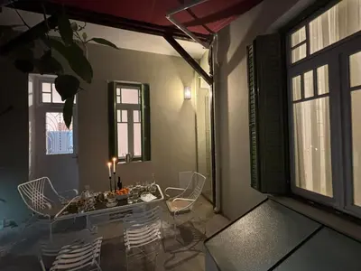 a dining room with a table and chairs and windows at Live in Athens, PANGRATI Fine Residence in Athens