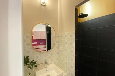 a bathroom with a mirror and a sink at Live in Athens, PANGRATI Fine Residence in Athens