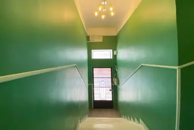 a hallway with a green wall and a door at Live in Athens, PANGRATI Fine Residence in Athens