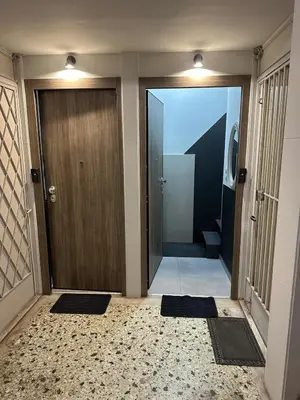 an entrance to a hallway with a door and two mats at Studio in the heart of the city in Athens