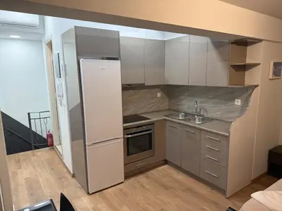 a small kitchen with a sink and a refrigerator at Studio in the heart of the city in Athens