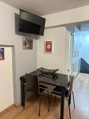 a dining room with a black table and chairs at Studio in the heart of the city in Athens