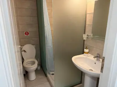 a small bathroom with a toilet and a sink at Studio in the heart of the city in Athens