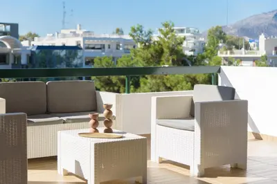 a patio with two chairs and a table with a table at Athenean Boutique Bliss in Athens