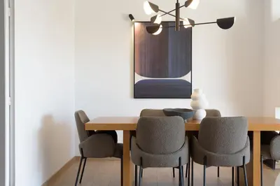 a dining room with a wooden table and chairs at Athenean Boutique Bliss in Athens
