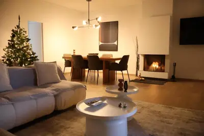 a living room with a christmas tree and a couch at Athenean Boutique Bliss in Athens