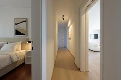 a white bedroom with a bed and a hallway at Athenean Boutique Bliss in Athens