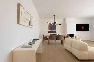 a living room with a white couch and a table at Athenean Boutique Bliss in Athens