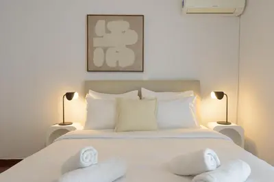 a bedroom with a bed with white towels on it at Athenean Boutique Bliss in Athens