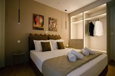 a bedroom with a large bed with white pillows at Venus house apart in Pagrati in Athens