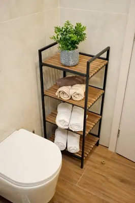 a towel rack with towels and a toilet in a bathroom at Venus house apart in Pagrati in Athens