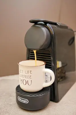 a coffee maker with a cup on top of it at Venus house apart in Pagrati in Athens