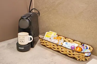 a basket with a coffee cup next to a microwave at Venus house apart in Pagrati in Athens