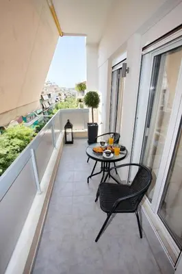 a balcony with a table and chairs on a balcony at Venus house apart in Pagrati in Athens