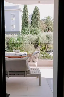 a room with a tub and a chair on a balcony at Aldi Seaside Suite in Athens