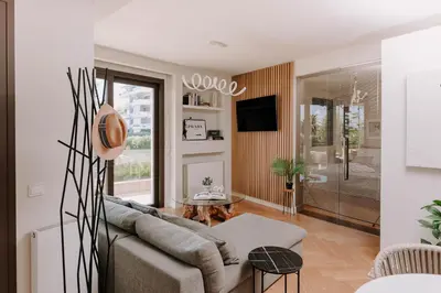 a living room with a couch and a tv at Aldi Seaside Suite in Athens