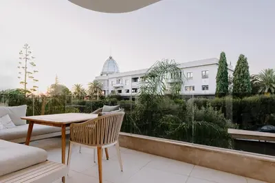 a balcony with a table and chairs and a building at Aldi Seaside Suite in Athens