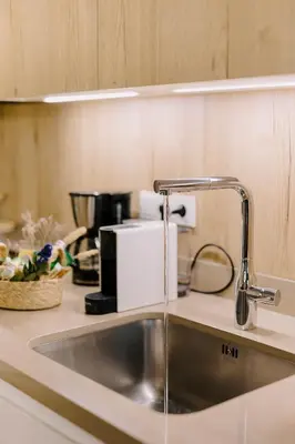 a kitchen counter with a sink and a coffee maker at Aldi Seaside Suite in Athens