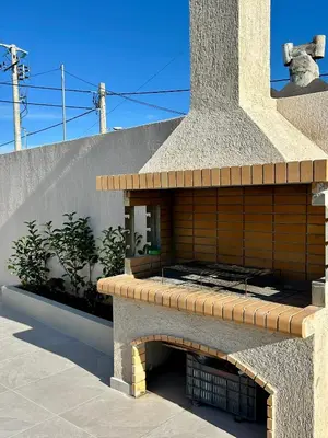 a building with a stone oven with a brick at Athens Layover Home in Koropíon