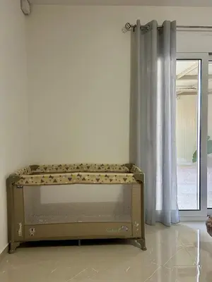 a bed in the corner of a room with a window at Athens Layover Home in Koropíon