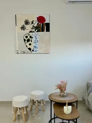 a living room with two tables and two stools at Athens Layover Home in Koropíon