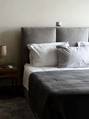 a bedroom with a bed with white sheets and pillows at 1 Bedroom Cozy Studio in Athens