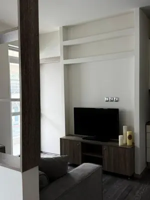 a living room with a couch and a flat screen tv at 1 Bedroom Cozy Studio in Athens