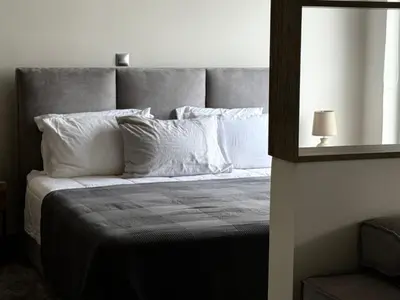 a bedroom with a large bed with white pillows at 1 Bedroom Cozy Studio in Athens
